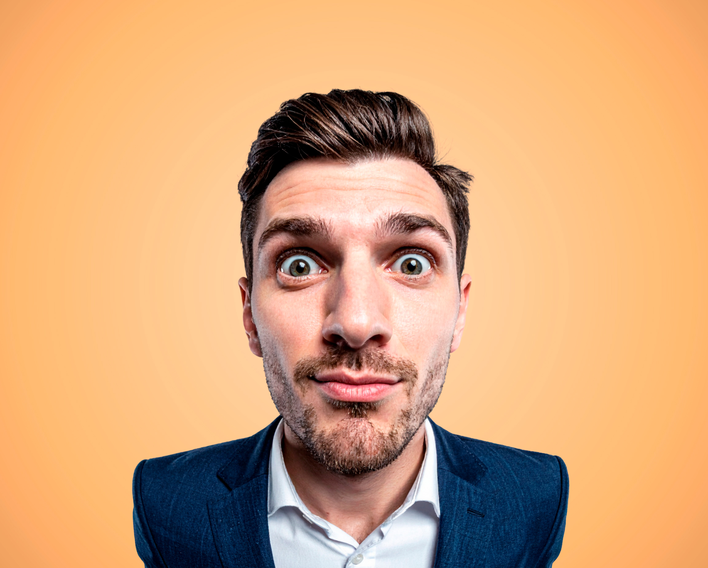 Man on orange background in pitchd brand style photography.