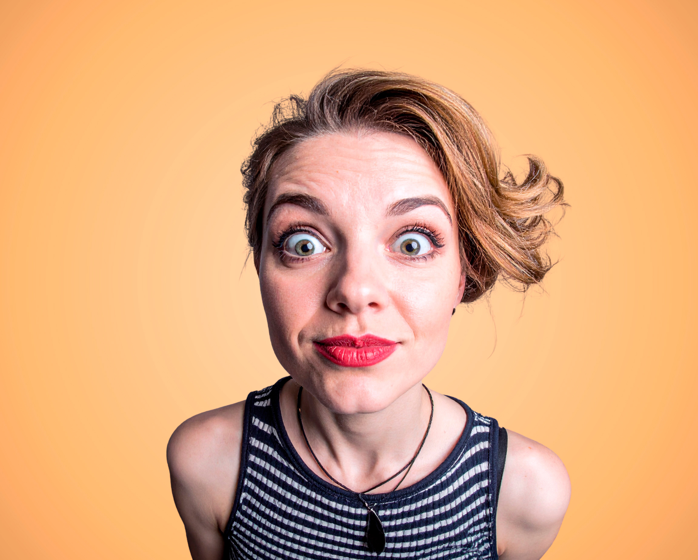 Woman on orange background in pitchd brand style photography.